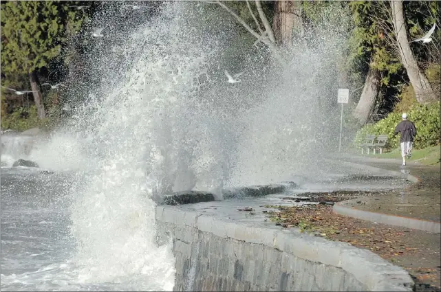  ?? IAN LINDSAY/PNG FILES ?? Waves crash into the Stanley Park seawall after a winter storm in 2006. Sea levels are predicted to rise by about one metre by 2100.