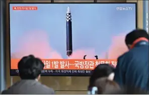  ?? (AFP) ?? People watch a television screen showing a news broadcast with file footage of a North Korean missile test, at a railway station in Seoul on Wednesday.