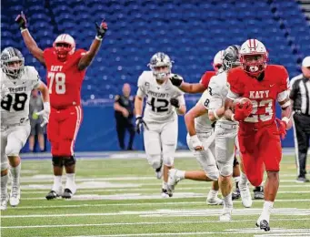  ?? ?? Katy’s Seth Davis is off to the races for one of his two TDs, the second of which tied the game in the final minutes. He finished with 257 yards and became the school’s all-time leading rusher.