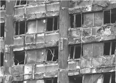  ??  ?? Damage to Grenfell Tower is seen following the catastroph­ic fire, in north Kensington, London. — Reuters photo