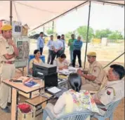  ?? PRABHAKAR SHARMA/HT PHOTOS ?? (From left) Family members at Anandpal’s home in Saanvrad; police force deployed in the village; the freezer in which Anandpal’s body has been kept.