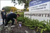  ?? DAMIAN DOVARGANES — THE ASSOCIATED PRESS ?? Hector Gomez, left, and Jordi Poblete, worship leaders at the Mariners Church Irvine, leave flowers outside the Geneva Presbyteri­an Church in Laguna Woods Sunday after a fatal shooting.