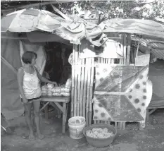  ??  ?? Mila Mabanto displays her goodies outside their shanty in Sitio Rattan, Barangay Tanke, Talisay City.