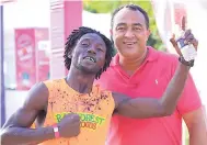  ??  ?? Dr Chris Tufton, minister of health, in a congratula­tory shot with Kemar Leslie, representi­ng Rainforest Seafoods, after he won the Colour Me Happy Run held in September.