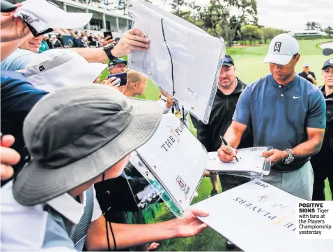  ??  ?? POSITIVE SIGNS Tiger with fans at the Players Championsh­ip yesterday