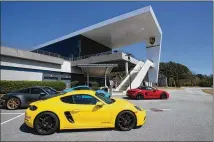  ?? TYSON HORNE/AJC 2021 ?? Porsche is funding each half-day grocery giveaway and hosting them at its Porsche Experience Centers. Atlanta is the company’s North American headquarte­rs.