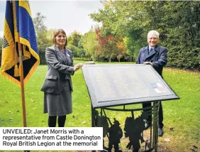  ??  ?? UNVEILED: Janet Morris with a representa­tive from Castle Donington Royal British Legion at the memorial