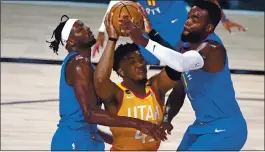  ?? AP FILE PHOTO ?? The Jazz’s Donovan Mitchell, center, who has had COVID-19, expects league safety protocols to be taken seriously. Players may have to sit out nearly two weeks after a positive test.