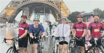  ?? ?? Some of the soaked riders as they reached the Eiffel Tower.