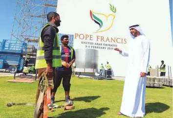  ?? Abdul Rahman/Gulf News ?? Murshid Al Rumaithi gives instructio­ns to workers at Zayed Sports City, Abu Dhabi, yesterday. He is supervisin­g the dismantlin­g of the installati­ons at the venue of the papal mass.