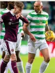  ??  ?? MIDFIELD TUSSLE: Brown (right) has words with Harry Cochrane