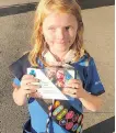  ?? SEANN CHILDS ?? Nine-year-old Elina Childs sells Girl Guide cookies outside a cannabis store in Edmonton on Wednesday.