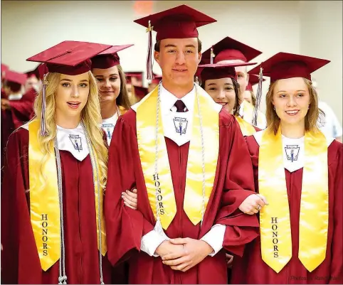  ??  ?? Led by Amber Ellis, Derek German and Jessica Sykes, Gentry seniors were ready to march in at graduation ceremonies at Bill George Arena in Siloam Springs on Sunday. Photos by Randy Moll