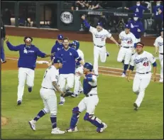  ?? Associated Press ?? CHAMPS — In this Oct. 27 photo, the Los Angeles Dodgers celebrate after defeating the Tampa Bay Rays 3-1 in Game 6 to win the World Series, 3-2, in Arlington, Texas.