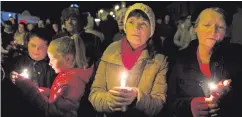  ??  ?? People gather for the vigil in Aughnacloy last night