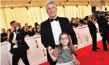  ?? — AFP photo ?? Alexander Payne and his daughter attend the 96th Annual Academy Awards at the Dolby Theatre in Hollywood, California.