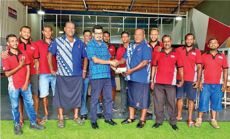  ??  ?? Al Hamd Smart Living Managing Director Ashfaaq Khan(fifth from left) hands over the cheque to Nadi Rugby Union’s president, Mataiasi Nabou, on October 21, 2020.