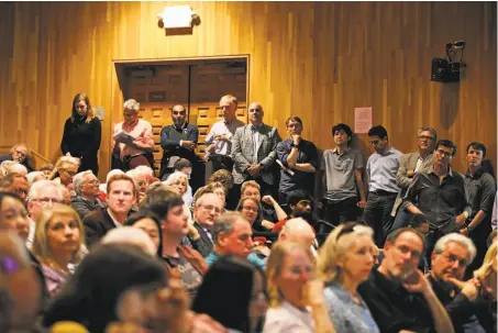  ?? Photos by Yalonda M. James / The Chronicle ?? Discussion­s on a plan to construct two buildings that could house faculty draws a crowd to Sibley Auditorium at UC Berkeley.