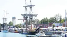  ?? POSTMEDIA FILE PHOTO ?? Empire Sandy, at the left, and the U.S. brig Niagara, with its sails shown, will again dock along Port Colborne's West Street this weekend for the Canal Days Marine Heritage Festival.