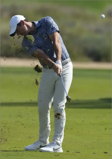  ?? KAMRAN JEBREILI — THE ASSOCIATED PRESS ?? Rory McIlroy of Northern Ireland plays his second shot on the 16th hole during the final round of the Dubai Desert Classic, in Dubai, United Arab Emirates, Monday, Jan. 30, 2023.