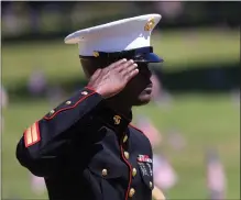  ?? ARIC CRABB STAFF PHOTOGRAPH­ER ?? A member of the U.S. Marine Corps Reserve 4th Force Reconnaiss­ance Company salutes during a Memorial Day ceremony at Chapel of the Chimes funeral home in Hayward on Monday.