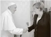  ?? L’Osservator­e Romano / Pool Photo via AP ?? Pope Francis and German Chancellor Angela Merkel shake hands on the occasion of their private audience Saturday at the Vatican.