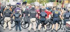  ?? JOE BURBANK/ORLANDO SENTINEL ?? Police block Colonial Drive at Orange Avenue as protesters march through downtown Orlando on Thursday.