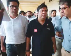  ?? AFP ?? Law enforcemen­t officers accompany Axact chief executive officer Shoaib Ahmad Shaikh as he arrives for a court appearance in Islamabad yesterday.