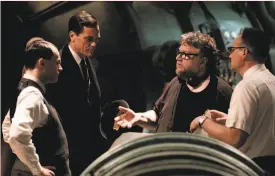  ??  ?? Above: Sally Hawkins with Doug Jones in “The Shape of Water.” Right: Guillermo del Toro (second from right) directs Michael Shannon (second from left) and others in his new creature feature, which is set in 1962.
