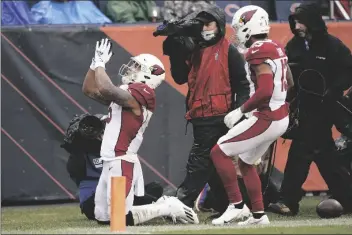  ?? NAM Y. HUH/AP ?? ARIZONA CARDINALS RUNNING BACK JAMES CONNER celebrates his touchdown as Christian Kirk watches during the first half of a game against the Chicago Bears Sunday in Chicago.