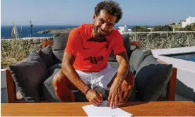 ?? ?? Mohamed Salah signs his new Liverpool contract, which runs to 2025. Photograph: Liverpool FC