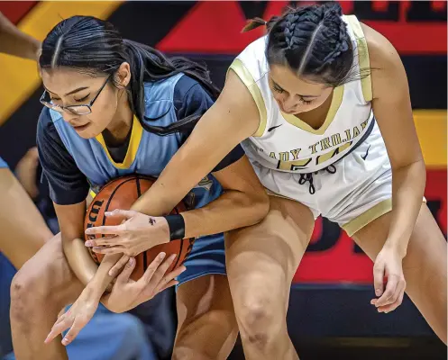  ?? JIM WEBER/NEW MEXICAN FILE PHOTO ?? Mesa Vista’s Shanae Silva, right, battles Dulce’s Alaina Vigil on Jan. 6 in the Northern Rio Grande Tournament. Mesa Vista, along with Dulce, Pecos and Penasco, are all competing in the Class 2A State Girls Basketball Tournament.