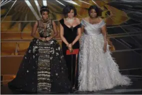  ?? PHOTOS BY CHRIS PIZZELLO/INVISION/AP ?? Janelle Monae, from left, Taraji P. Henson, and Octavia Spencer present the award for best documentar­y feature at the Oscars on Sunday, at the Dolby Theatre in Los Angeles.