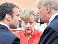  ??  ?? FREE WORLD: French President Emmanuel Macron, German Chancellor Angela Merkel and US President Donald Trump conferring at the G20 meeting in Hamburg, Germany.