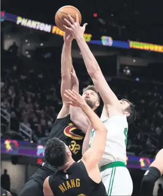  ?? AP ?? Dean Wade (32) blocks a Luke Kornet shot during Tuesday’s NBA game in Cleveland. Wade made five 3-pointers and scored 20 points in the fourth quarter as the Cleveland Cavaliers overcame a 22-point deficit to beat the visiting Boston Celtics 105-104