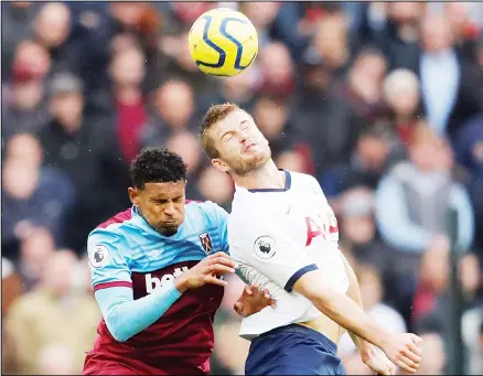  ??  ?? West Ham’s Sebastien Haller (left), and Tottenham’s Eric Dier jump for the ball during the English Premier League soccer match between West Ham and
Tottenham at London Stadium in London on Nov 23. (AP)