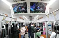  ?? AP Photo/Ahn Young-joon ?? ■ Screens warning of the coronaviru­s are shown Wednesday in a subway train in Seoul, South Korea.