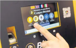  ?? BLOOMBERG ?? A customer uses a Bitcoin automated teller machine (ATM), operated by BitBase, inside a cryptocurr­ency exchange in Madrid, Spain earlier this year.