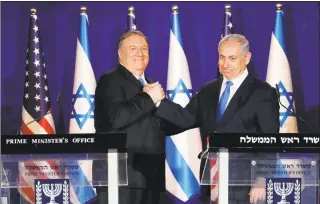  ?? Amir Cohen / Associated Press ?? Secretary of State Mike Pompeo, left, shakes hands with Israeli Prime Minister Benjamin Netanyahu, during their visit to Netanyahu's official residence in Jerusalem, Thursday. Netanyahu praised President Donald Trump’s recognitio­n of its control over the Golan Heights as a holiday “miracle.”