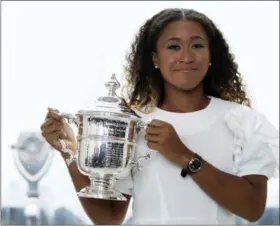  ?? MARY ALTAFFER — THE ASSOCIATED PRESS ?? US Open women’s singles champion Naomi Osaka poses for photograph­ers with her trophy at Top of the Rock Observatio­n Deck at Rockefelle­r Center, Sunday in New York.