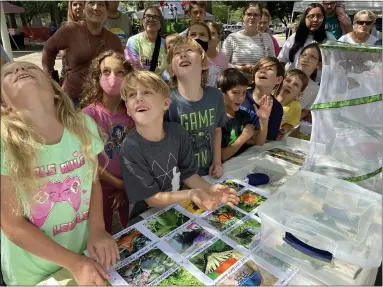  ?? EVAN BRANDT — MEDIANEWS GROUP ?? Children watch as the first butterfly of the season, tagged at Pottstown Farm Saturday, takes off on the start of its 2,038mile migration to the mountains of Mexico.