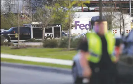  ?? AP PHOTO ?? Emergency vehicles sit in front of a Fedex distributi­on centre where a package exploded Tuesday in Schertz, Texas. Authoritie­s believe the package bomb is linked to the recent string of Austin bombings.