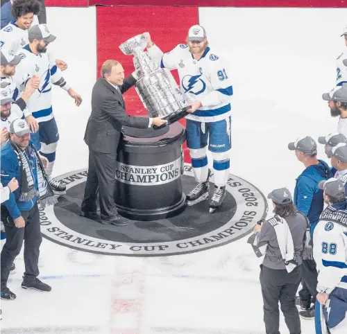 ?? JASON FRANSON/AP ?? Lightning’s Steven Stamkos is presented the Stanley Cup from NHL commission­er Gary Bettman on Sept. 28 in Edmonton.