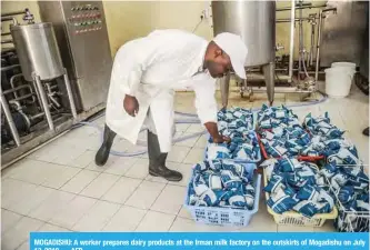  ??  ?? MOGADISHU: A worker prepares dairy products at the Irman milk factory on the outskirts of Mogadishu on July 13, 2018. — AFP
