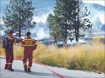  ?? JAMES MILLER/The Okanagan Weekend ?? Members of the Penticton Fire Department at the scene of a grass fire Friday on Westhill Road.