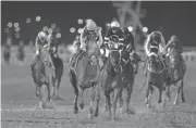  ?? FRANCOIS NEL/GETTY IMAGES ?? Arrogate, ridden by Mike Smith, wins the Dubai World Cup on Saturday in Dubai, United Arab Emirates.