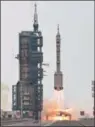  ?? ?? .Gui Haichao (L) payload expert, Zhu Yangzhu (C) space flight engineer and commander Jing Haipeng (R) wave during the seeing-off ceremony before boarding a Long March-2F carrier rocket carrying the Shenzhou-16 Manned Space Flight Mission at the Jiuquan Satellite Launch Centre in China’s Gansu province on Tuesday. (AFP)