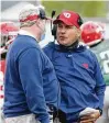  ?? DAVID JABLONSKI /STAFF ?? Dayton assistant football coach Mark Ewald (right) confers with head coach Rick Chamberlin during a 2021 spring scrimmage at Welcome Stadium.