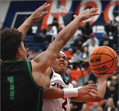  ?? PHOTO BY MILKA SOKO ?? Roosevelt’s Myles Walker, right, goes up for a shot against St. Joseph’s Julius Price in Saturday’s CIF State Open Division regional semifinal.