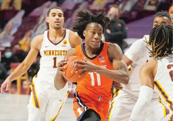  ?? AP ?? A triple-double by Ayo Dosunmu (driving past Tre’ Williams) was one of the highlights of the Illini’s seventh consecutiv­e victory. Dosunmu had 19 points, 10 rebounds and 10 assists.